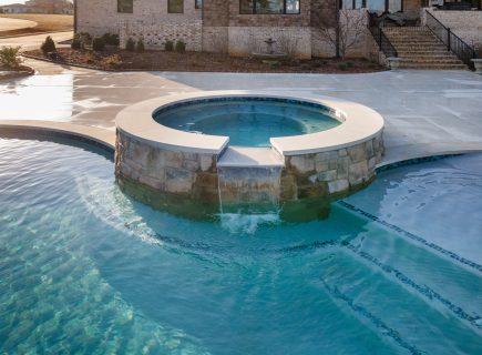 circle spa with fountain pouring into pool