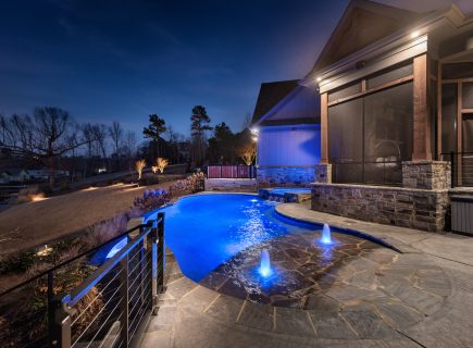 night time freeform pool with fountains