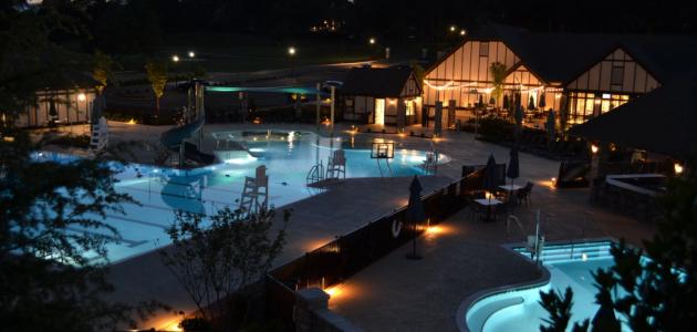 a vacation resort with swimming pool and lots of pool lighting