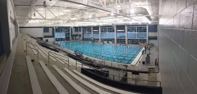 a large olympic swimming pool with seating