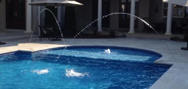 two jet stream fountains creating water arches in pool